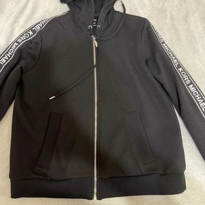 Black and white Michael Kors zip up jacket with hoodie… size L
